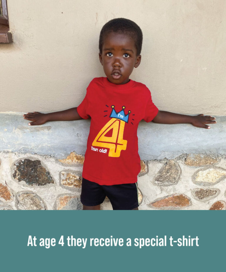 A child getting a special shirt for their birthday.