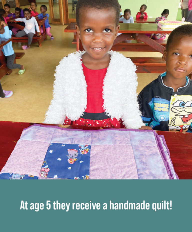 A child getting a quilt for their birthday.