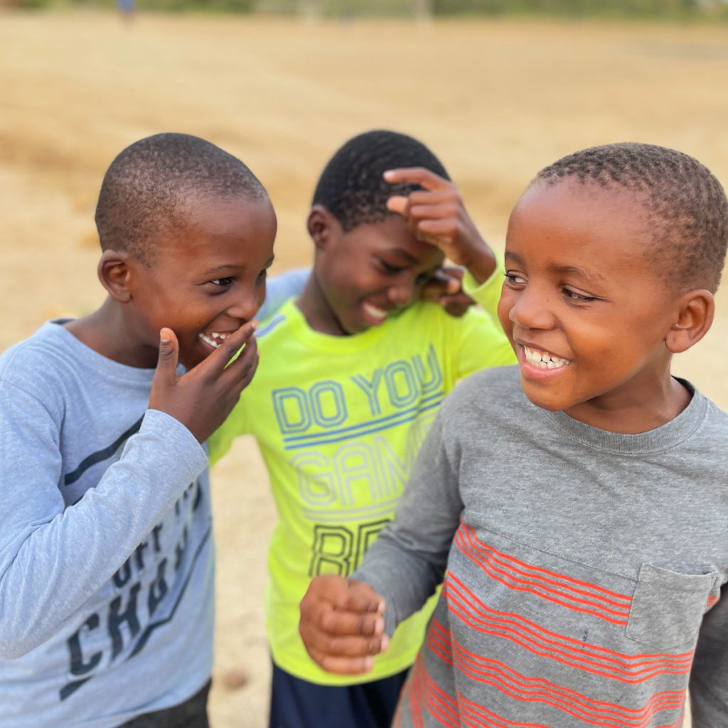 A few children smiling and laughing.
